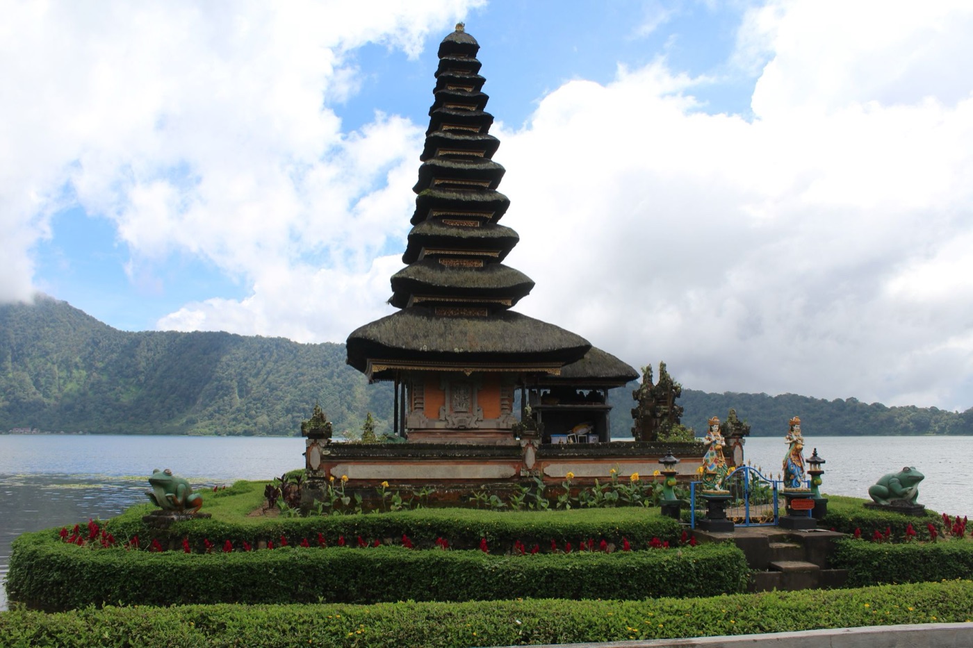 Pura Ulun Danu Beratan temple floating on Lake Beratan, with misty mountains in the background.